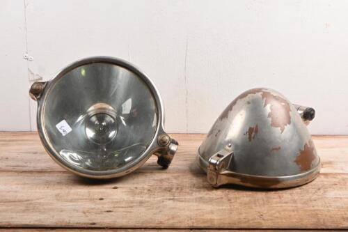 HEADLAMPS: Two vintage J 200a headlamps, flat glass with metal housing; overall diameter of 22.5cm