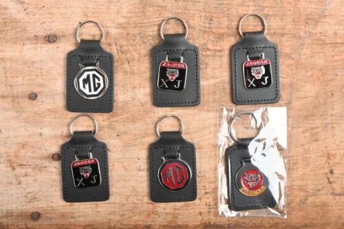 25A · JAGUAR/MG: A collection of six unused enameled key chains including Jaguar & MG