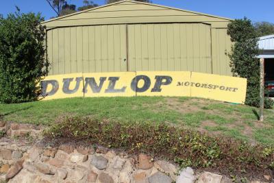 DUNLOP: A large ‘DUNLOP MOTORSPORT’ tin sign ex- Surfers Paradise International Raceway (740cm wide).