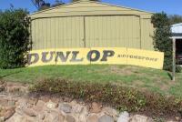 DUNLOP: A large &lsquo;DUNLOP MOTORSPORT&rsquo; tin sign ex- Surfers Paradise International Raceway (740cm wide).