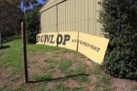 DUNLOP: A large &lsquo;DUNLOP MOTORSPORT&rsquo; tin sign ex- Surfers Paradise International Raceway (740cm wide). - 4