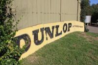 DUNLOP: A large &lsquo;DUNLOP MOTORSPORT&rsquo; tin sign ex- Surfers Paradise International Raceway (740cm wide). - 9