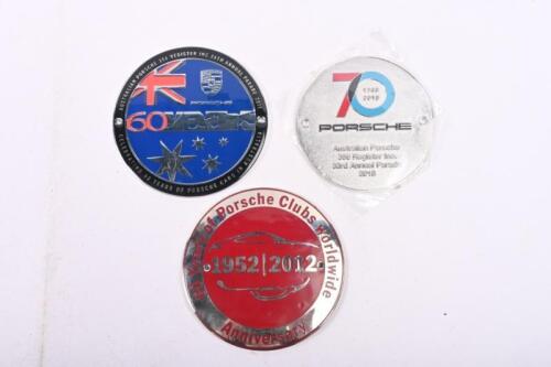 PORSCHE: Three round Porsche grill badges including 356 Register 26th Annual Parade 2011 and two others.