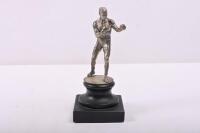 BOXING: A circa 1930s boxing figure/mascot in silver plated metal, mounted on stepped stone base, 18cm high overall