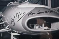 BRABHAM/TAURANAC: Two black and white photographs of Sir Jack Brabham & Ron Tauranac inspecting their MRD Brabham at the Weybridge factory in the 1960s, each image hand signed by Jack and Ron in black. - 2