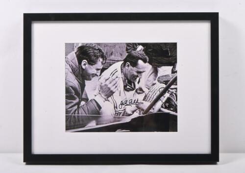 BRABHAM: A black and white photograph of Sir Jack Brabham and Frank Hallam from Repco in the mid-1960s, signed by Jack in black. 42.5cm wide, 32.5cm high.