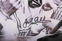 BRABHAM: A black and white photograph of Sir Jack Brabham and Frank Hallam from Repco in the mid-1960s, signed by Jack in black. 42.5cm wide, 32.5cm high. - 2