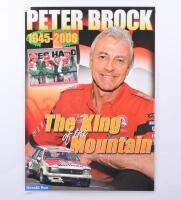 BROCK: A double sided laminated poster by the Herald Sun&nbsp;commemorating the passing of 'The King of the Mountain' Peter Brock 1945-2006. 43cm wide, 60cm high.
