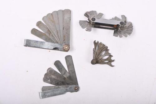 TOOLS: Four tools, including feeler gauges and a cute miniature spanner set