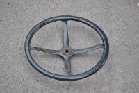STEERING WHEEL: An early timber rimmed cast iron steering wheel, 43cm diameter [Location: Birregurra]