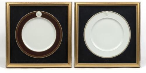 Two framed Versace&nbsp;plates by Rosenthal Medusa porcelain dinner sized plates with Greek key borders and embossed Versace Medusa head. Approx 31cm diameter. Framed by Art Conservation Framers Melbourne. Frame Measure 44cm wide, 43.5cm high.