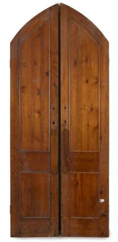 A pair of solid timber arched doors, likely removed from a church, 240cm high, 49.5cm wide