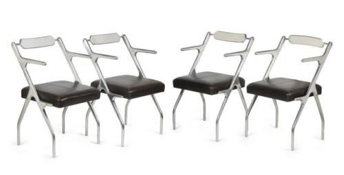 A set of four aluminium mid-century style heavy armchairs with leather cushions with white stitching, 85.5cm high [SALEROOM NOTICE]