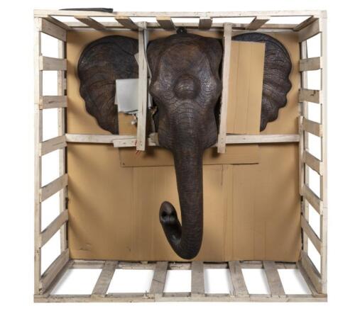 A large and impressive&nbsp;wall mounted timber elephant head with faux&nbsp;tusks and curved&nbsp;trunk, with detailed carvings, currently within timber traveling crate approx. 153.5&nbsp;high, 155&nbsp;wide