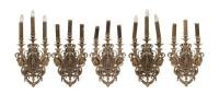 An impressive set of five gilt bronze wall lights each with a central eagle supporting floral scrolls, 60cm high, 33cm wide.