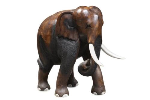 A small solid teak&nbsp;elephant with painted&nbsp;timber&nbsp;tusks, 66cm high, 56cm long, 41cm wide