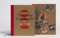A large hard cover book titled '100 Legendary Trunks Louis Vuitton', with slip cover