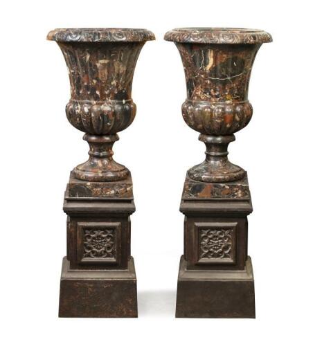 A fine pair of Italian Neo-Classical style campana urns, 20th century, 73cm high, 33cm wide, together with a modern cast iron pedestal base, each 127cm overall high.