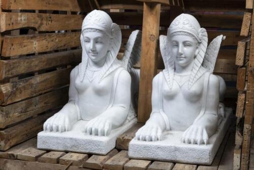 A impressive pair of heavy carved stone Egyptian winged&nbsp;Egyptian sphinx sculptures, 121cm high, 74cm long, 37.5cm wide, fitted within timber crate.&nbsp;&nbsp;