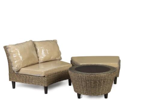 A set of outdoor cane furniture comprising of lounge chair, ottoman and glass topped table, with interchangeable cushions.