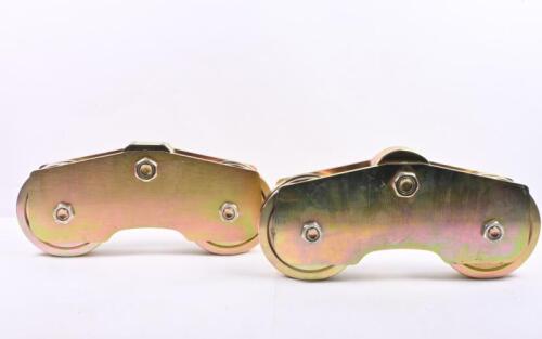 GATE ROLLERS: A pair of heavy metal gate rollers with brackets