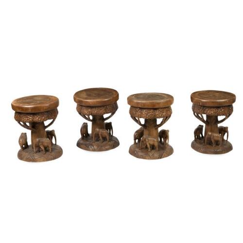 A set of four solid teak carved elephant stools, 47cm high, 40cm wide