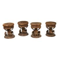 A set of four solid teak carved elephant stools, 47cm high, 40cm wide
