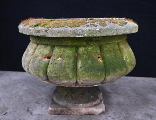 An antique hand carved stone planter on pedestal base, 38cm high, 50cm diameter
