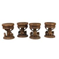 A set of four solid teak carved elephant stools, 47cm high, 40cm wide