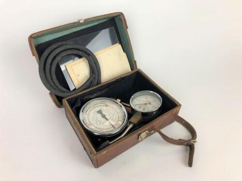 VANE GAUGES: Two Vane Electrical Systems gauges, Vacuum and Fuel Pump and Compression gauges in fitted leather case