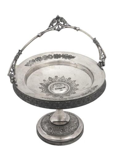 CAKE STAND: A silver trophy cake stand, dated 1884, depicts intricate​​​​​​​ etched design, 19cm high, 26cm wide