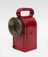 SIGNAL LAMP: An interesting small electric handheld signal lamp, curved post box style shape. 21cm tall.
