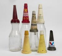 OIL BOTTLES: Four assorted&nbsp;oil bottles and three tops&nbsp;from various brands.