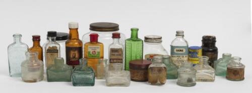 BOTTLES: A collection of various glass containers including ink wells and medicine bottles.