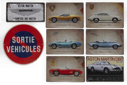 SIGNS: A selection of eight reproduction tin signs including Porsche, Ferrari, Aston Martin etc. As well as an aluminum 'SORTIE VEHICULES' sign.