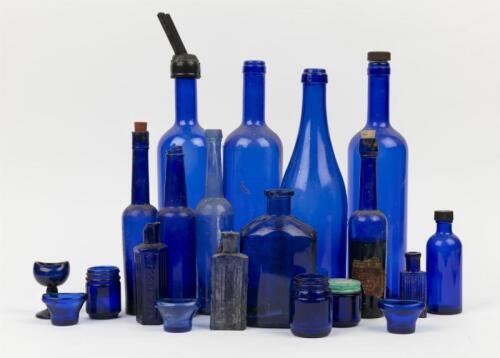 BLUE GLASS: A selection of vintage blue glass bottles and jars, tallest 36cm high
