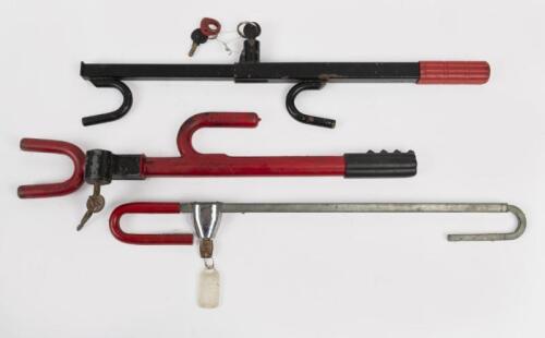 WHEEL LOCK: A collection of three steering wheel locks, all have original keys and lock.