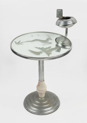 TABLE: An Art Deco style chrome/bakelite mirrored smokers table with ashtray and matchbox holder, decorated with an etched Stag. 67cm high, 40cm wide