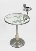 TABLE: An Art Deco style&nbsp;chrome/bakelite mirrored smokers table with ashtray and matchbox&nbsp;holder, decorated with an etched Stag.&nbsp;67cm high, 40cm wide&nbsp;