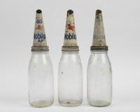 MOBIL: A set of three One Quart&nbsp;Mobil glass oil bottles with tin Mobil pourers&nbsp;