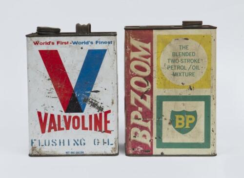 CANS: Two oil cans one 'BP-ZOOM 2 Stroke Mix', and one 'Valvoline Flushing Oil'.