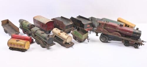 MODEL RAILWAY: A collection of three clockwork tinplate locomotives and assorted tenders and wagons.