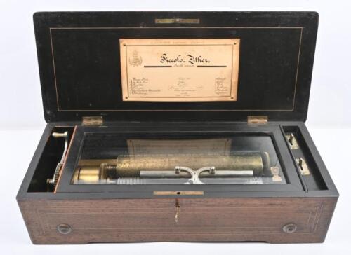 MUSIC BOX: An antique Swiss made music box by 'F Cochon Fabricant Geneva', brass tubular design, box with inlay design to lid. 54cm wide, 14cm high, 22cm deep.