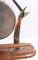 DINNER GONG: An antique dinner gong with horns mounted on wooden base, gong hanging from trumpets, complete with period striker. 38cm high - 4