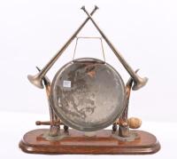 DINNER GONG: An antique dinner gong with horns mounted on wooden base, gong hanging from trumpets, complete with period striker. 38cm high - 8