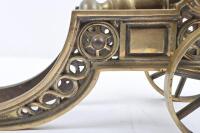 CANNON: A decorative brass cannon on wheels, approx 38cm long. - 2