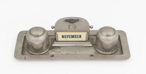 A circa 1930s silver plate desk piece including twin inkwells and date calendar, with Bentley motif