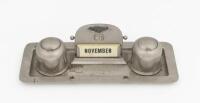 A circa 1930s silver plate desk piece including twin inkwells and date calendar, with Bentley motif