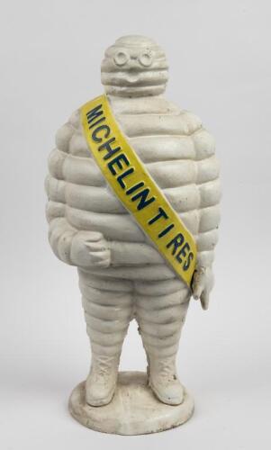 MICHELIN: A heavy cast iron reproduction standing Michelin Bibendum figure, 55cm high