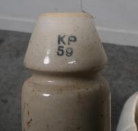 INSULATORS: A large selection of ceramic telephone wire insulators, mostly affixed to wooden posts. - 4